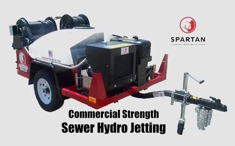 Commercial sewer hydro jetting machine on a trailer, red and white, with the Spartan logo.