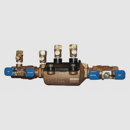 Bronze backflow preventer with blue handles and brass valves.