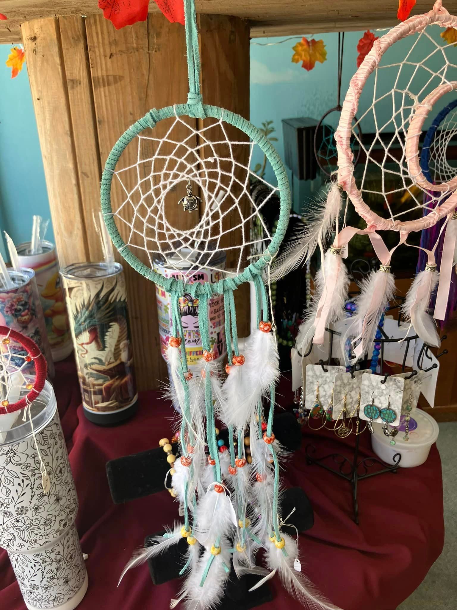 There are many different types of dream catchers on the table.