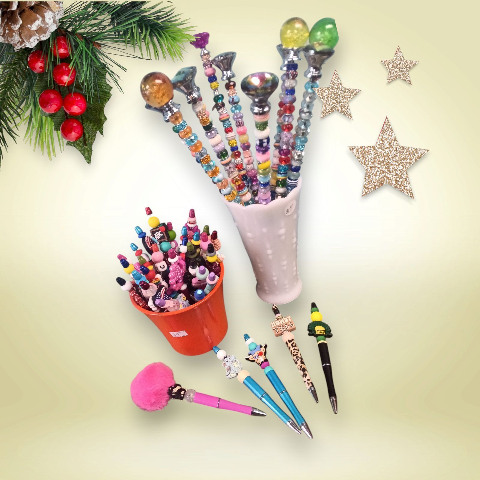 A bunch of pens and pencils with christmas decorations in the background