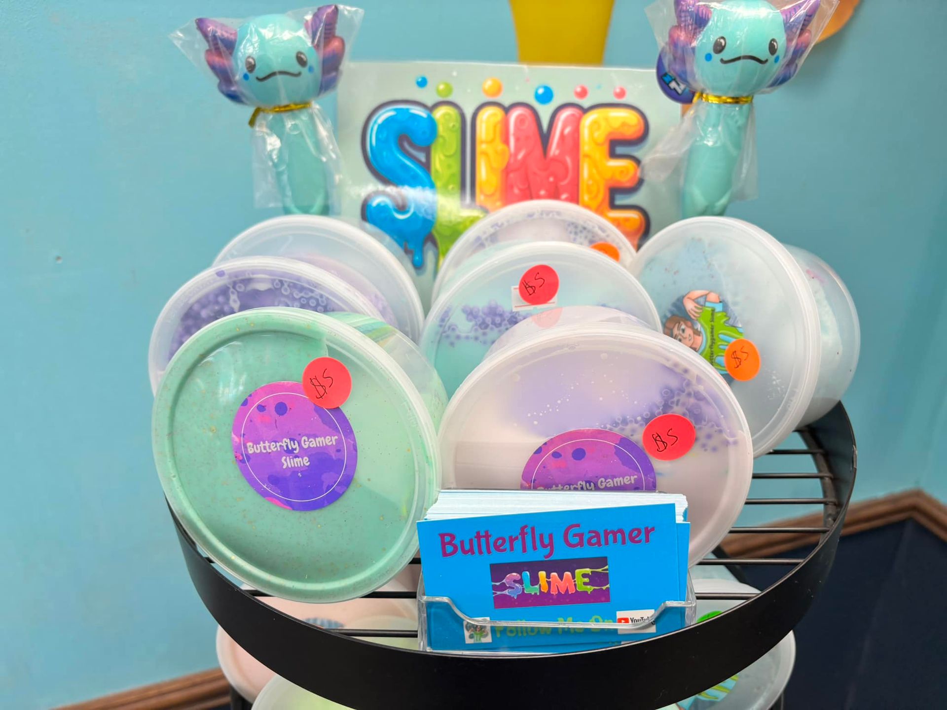 A display of different types of slime including butterfly gamer slime