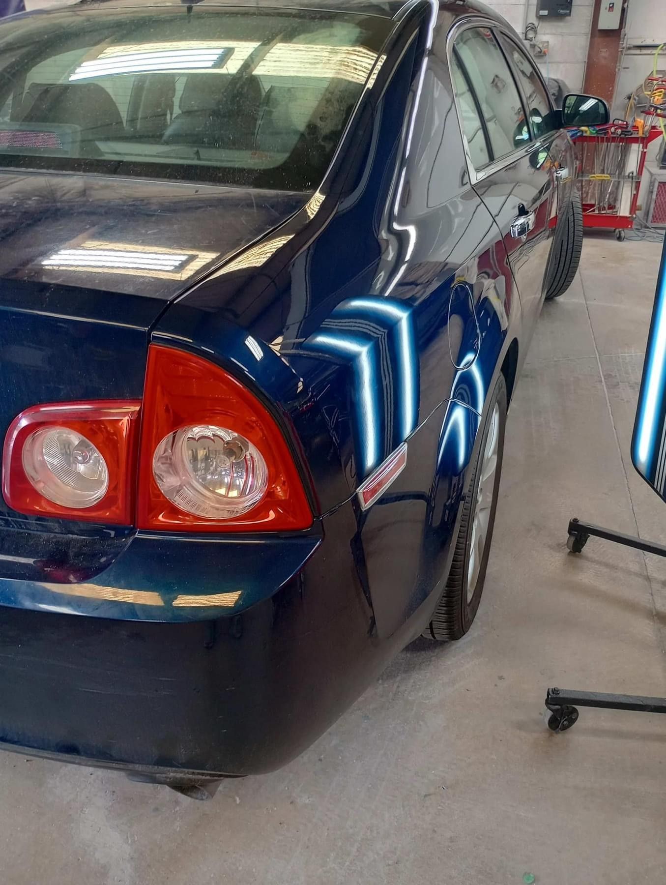 A blue car with red tail lights