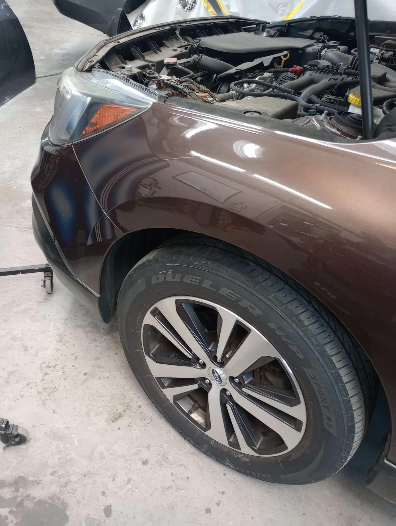 A brown car in a repair shop