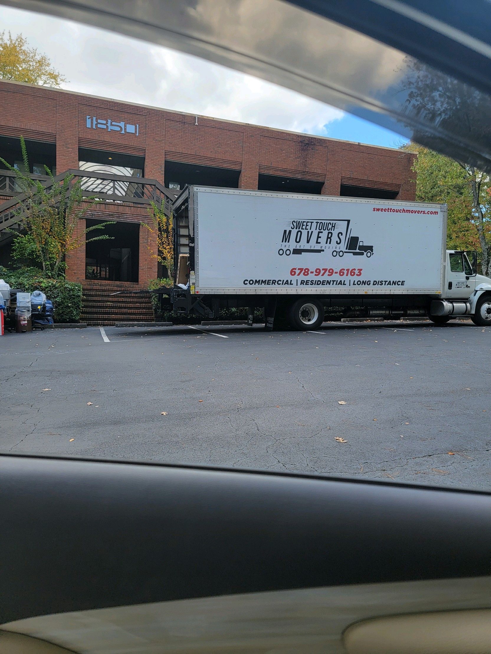 Worker loading blue and orange carts into a truck’s cargo bay