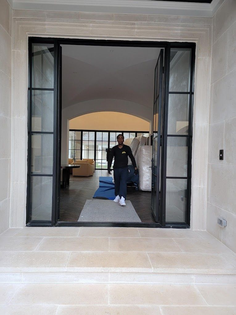A man is standing in the doorway of a house.