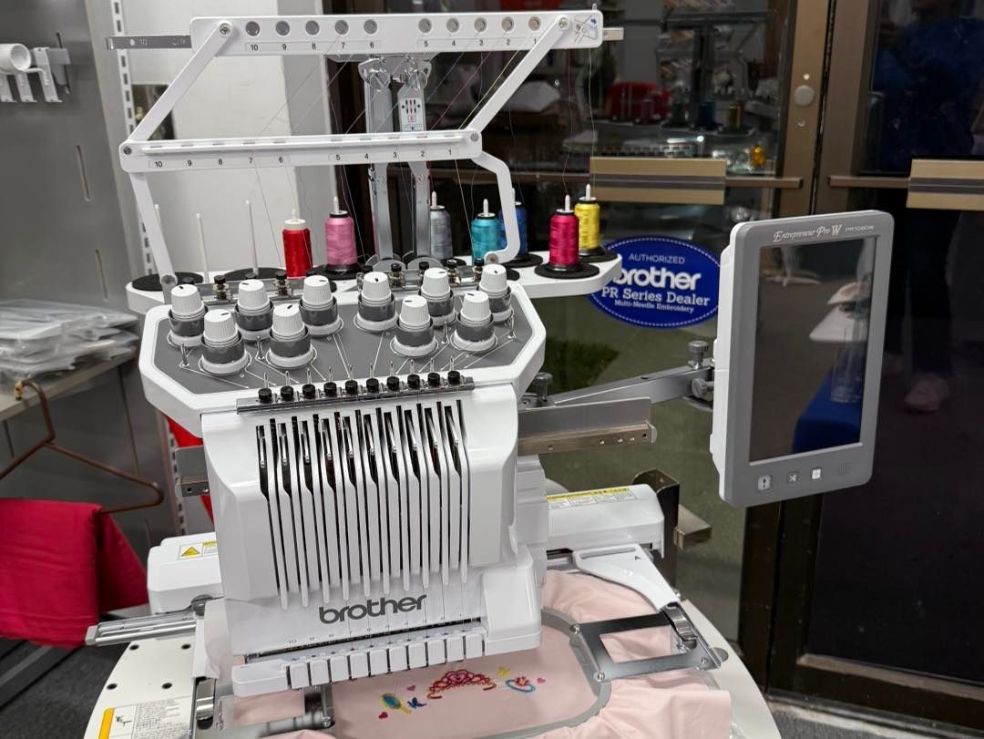 Brother embroidery machine with multiple thread spools and a touch screen interface