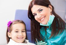 Dentist with little girl