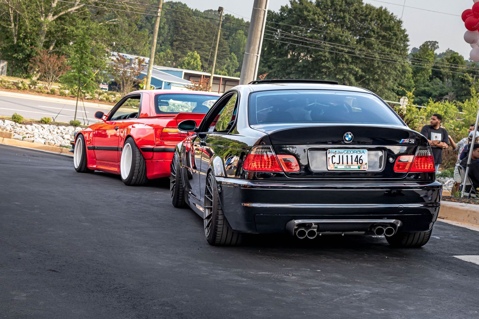 Two cars are parked next to each other on the side of the road.