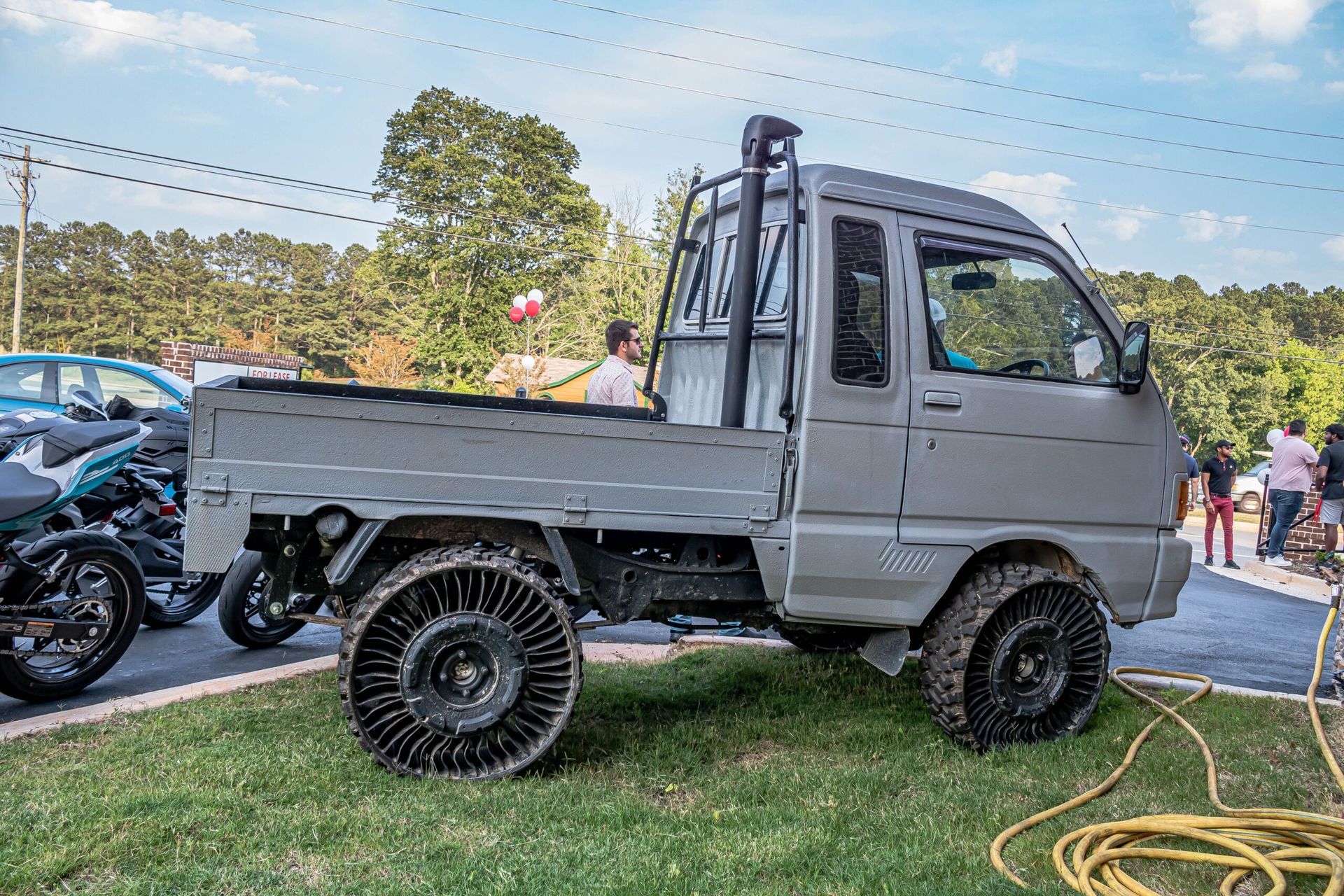 A small truck is parked on the grass
