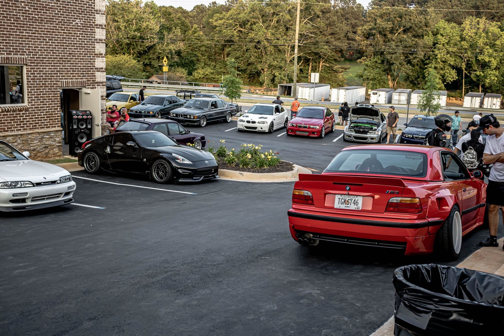 A group of cars are parked in a parking lot.