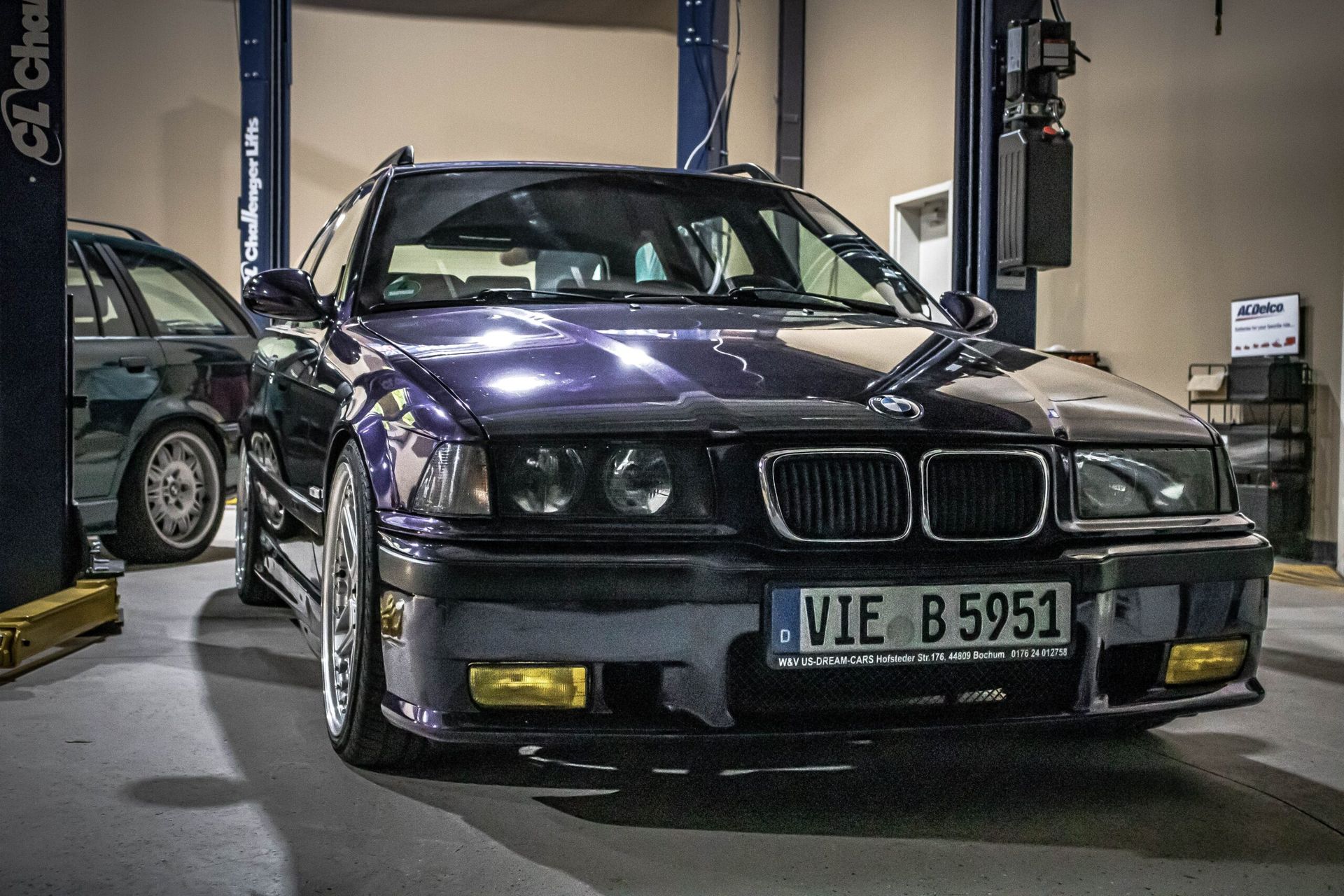 A purple bmw with a license plate