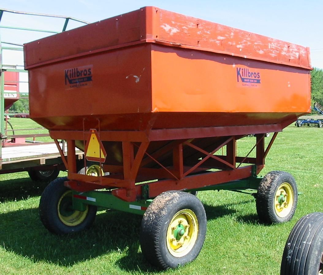 A kline wagon is parked in a grassy field