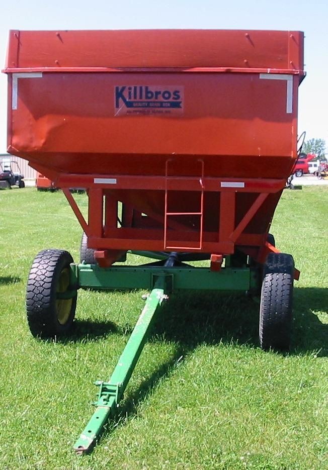 A red killbros trailer is parked in the grass