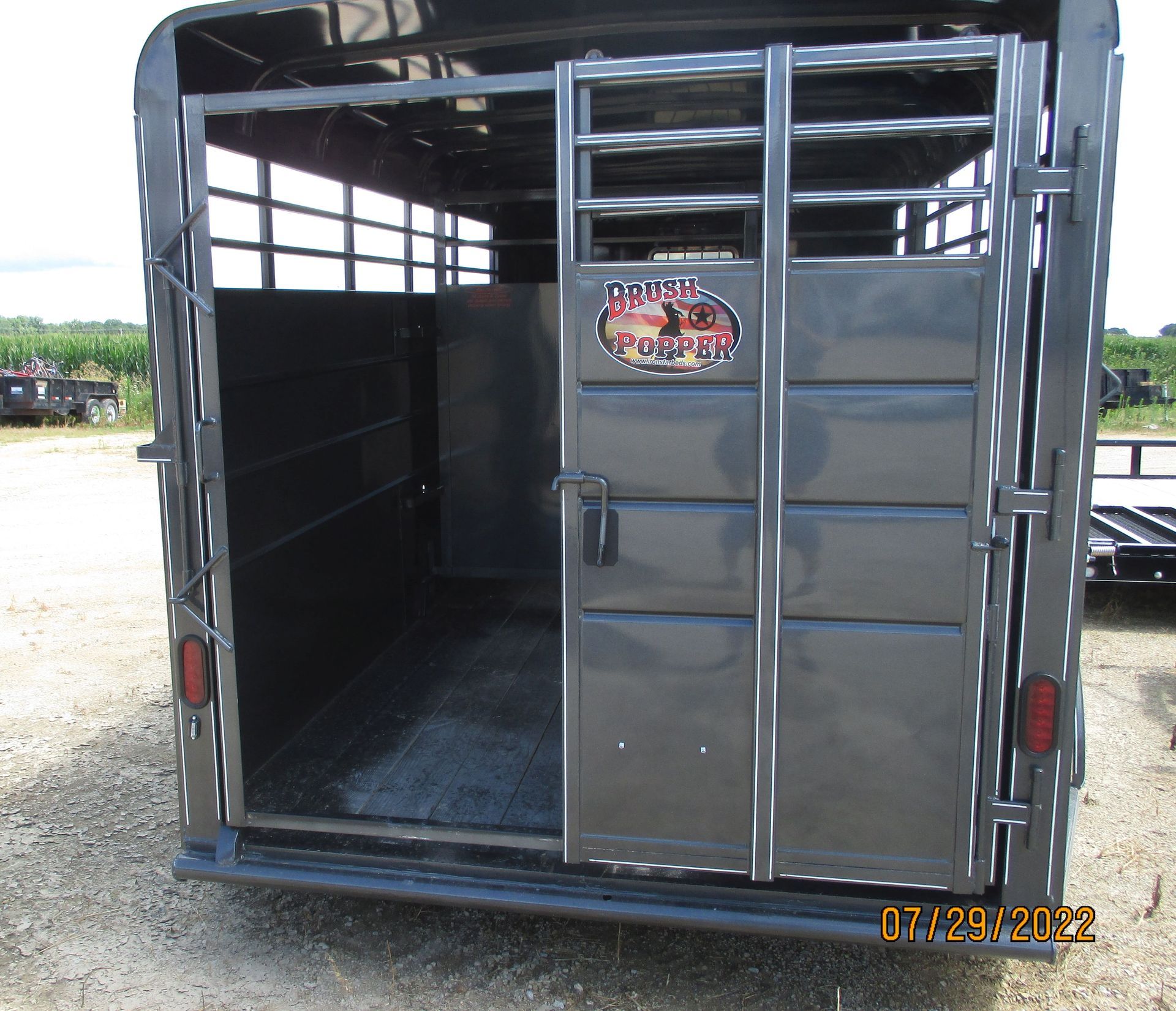 A horse trailer with a sticker on the side that says ' u.s. beef '