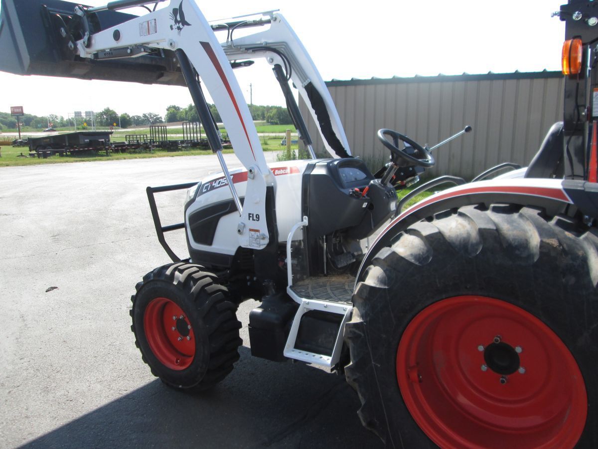 A white and red tractor is parked in a parking lot