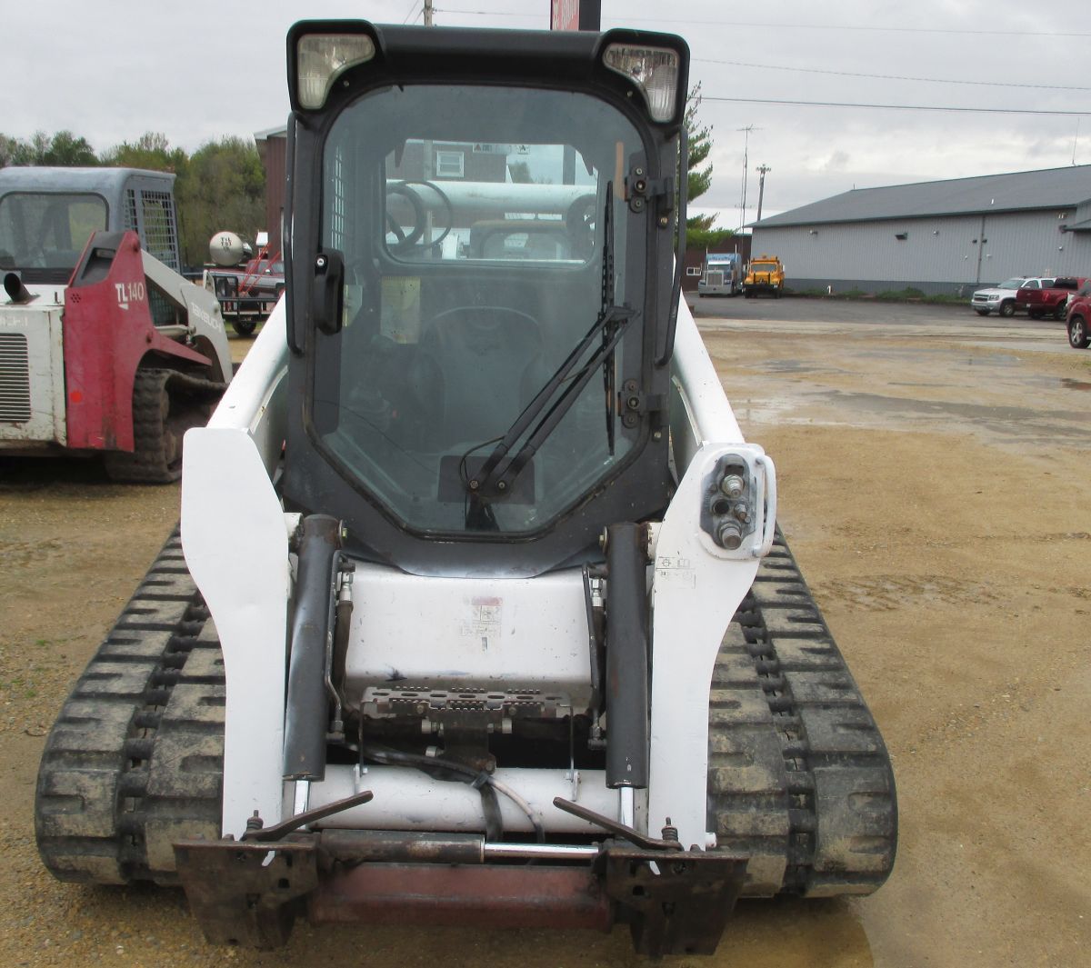 A bobcat skid steer is parked in a parking lot