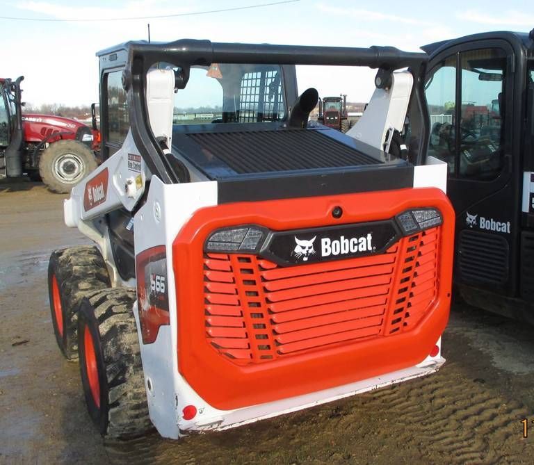 A bobcat tractor is parked next to another bobcat tractor