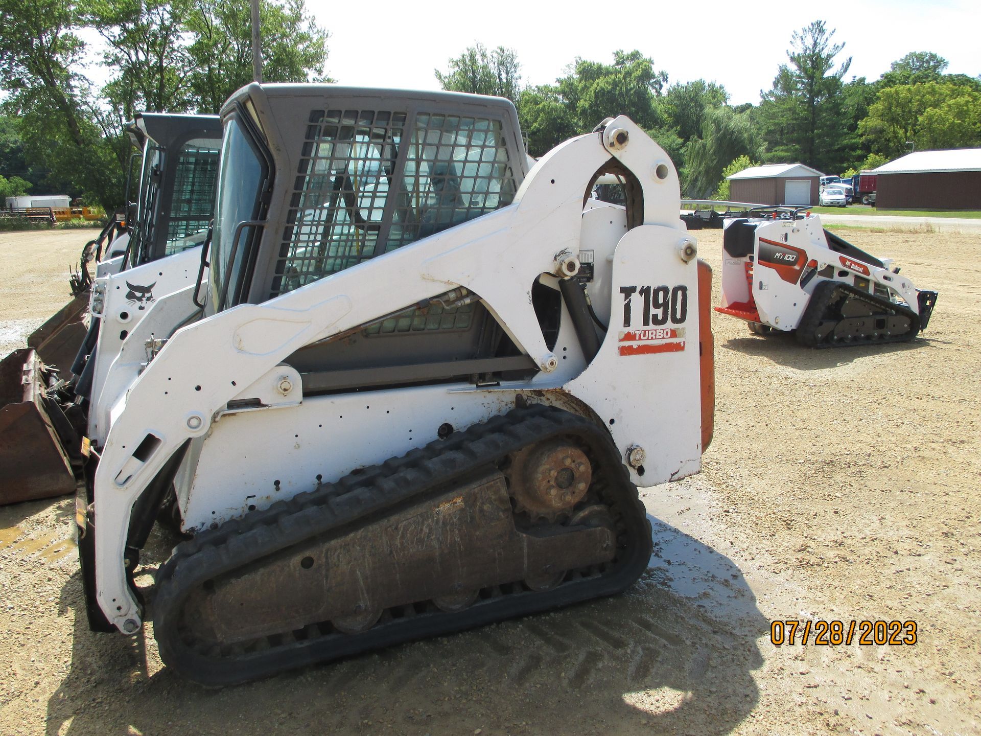 A bobcat t190 is parked in a dirt field