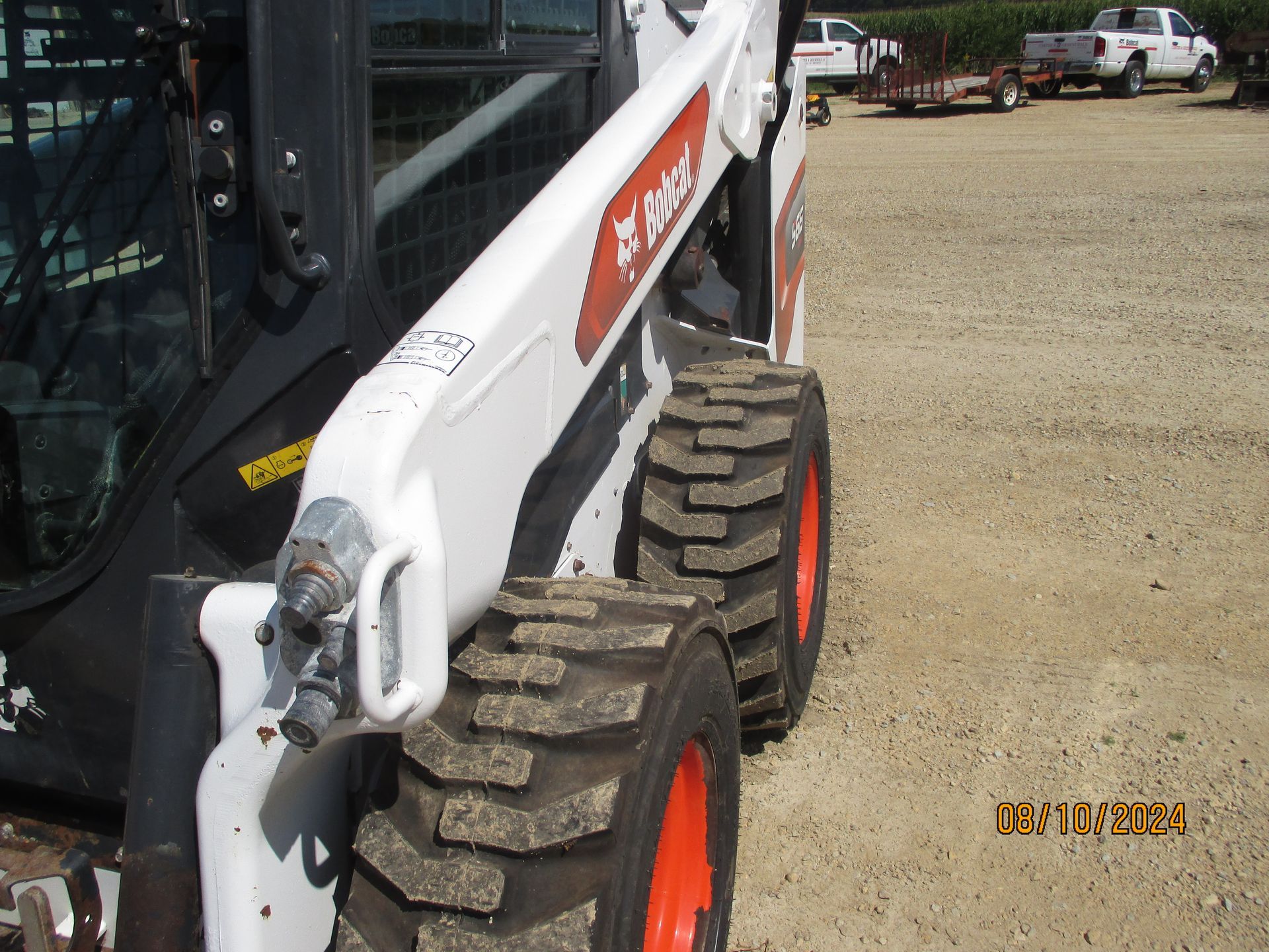 A bobcat tractor is parked in a gravel lot