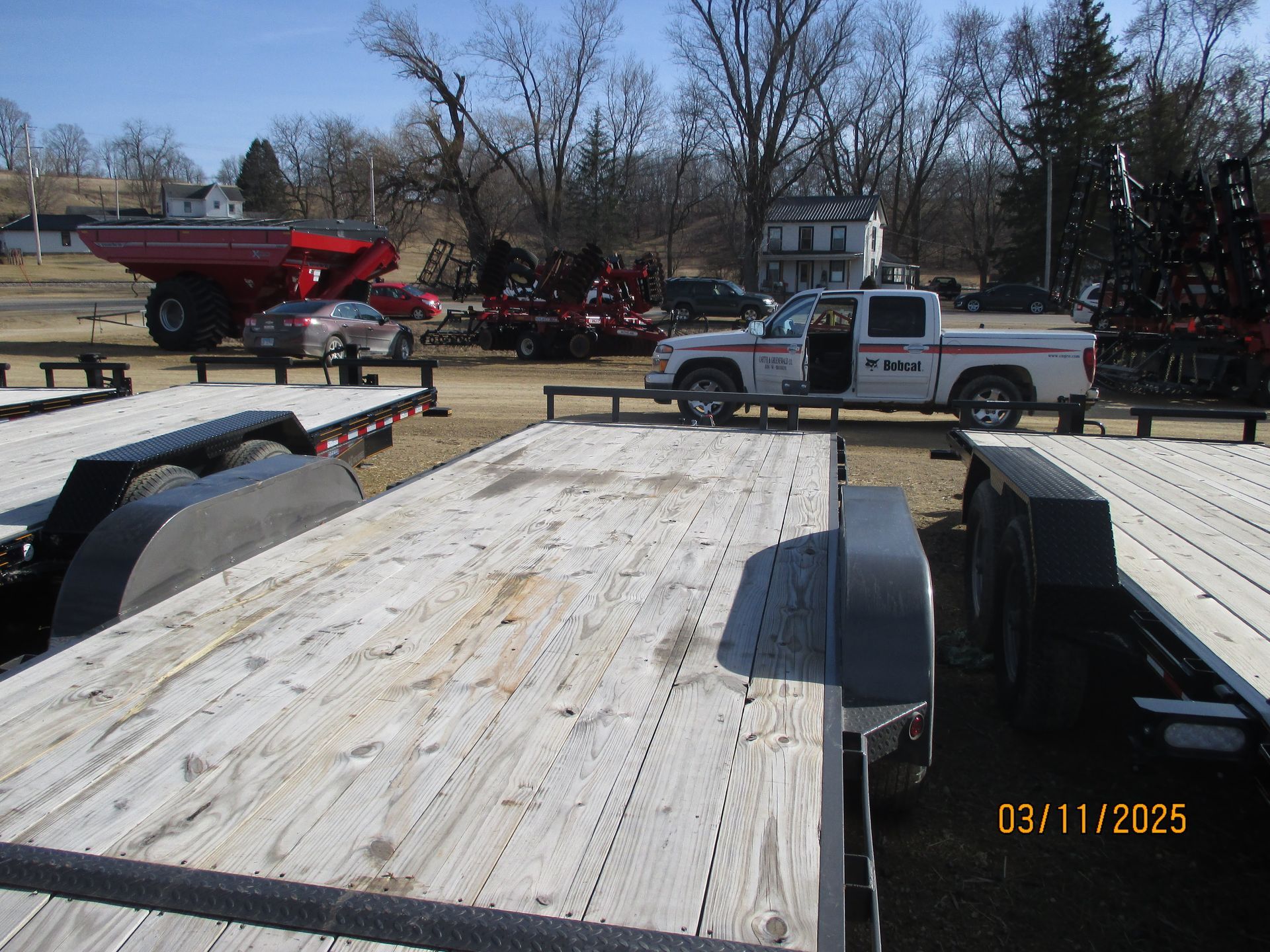 A pickup truck is parked on the back of a trailer