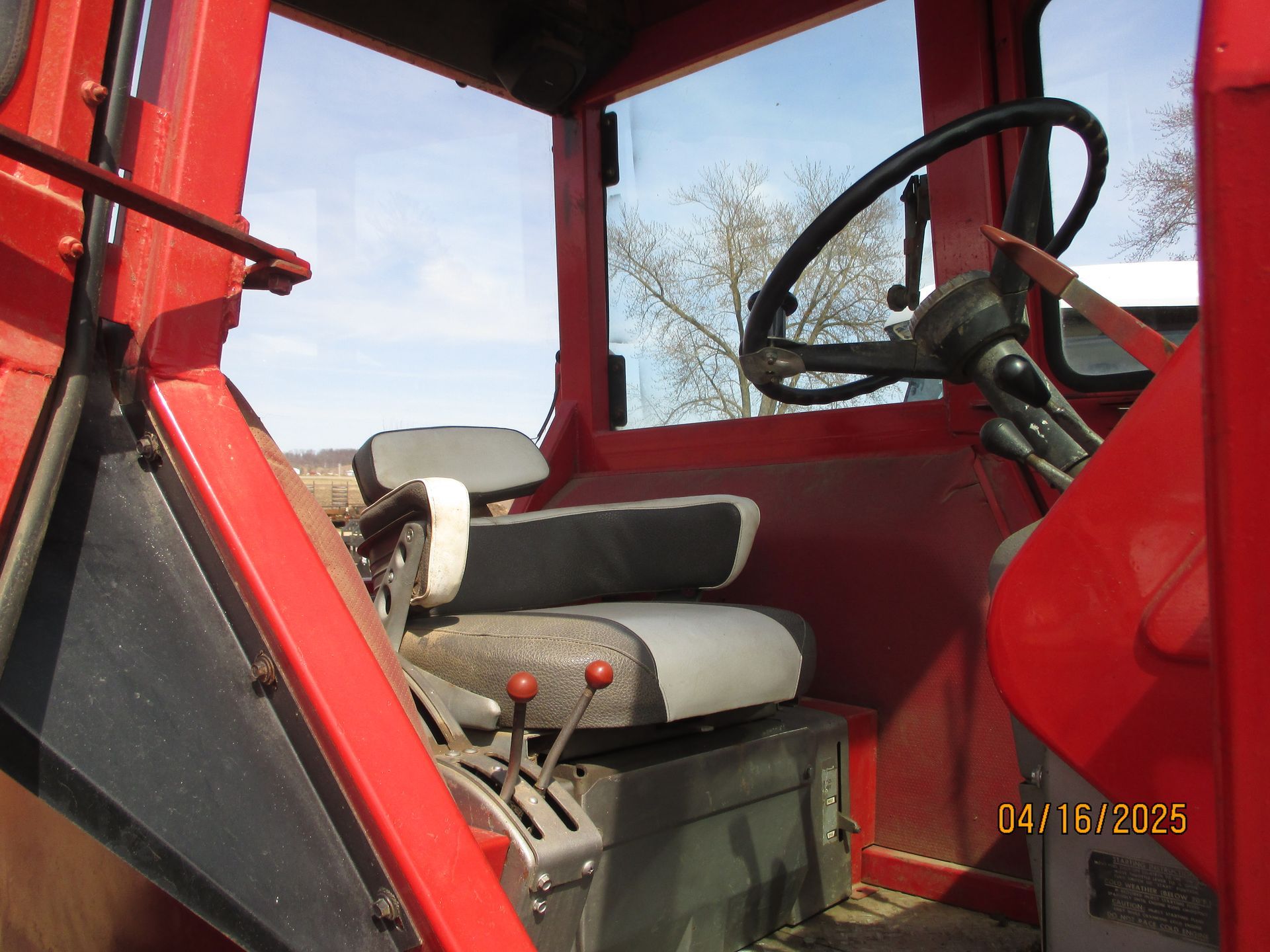 A picture of the inside of a red tractor was taken on april 16 2025