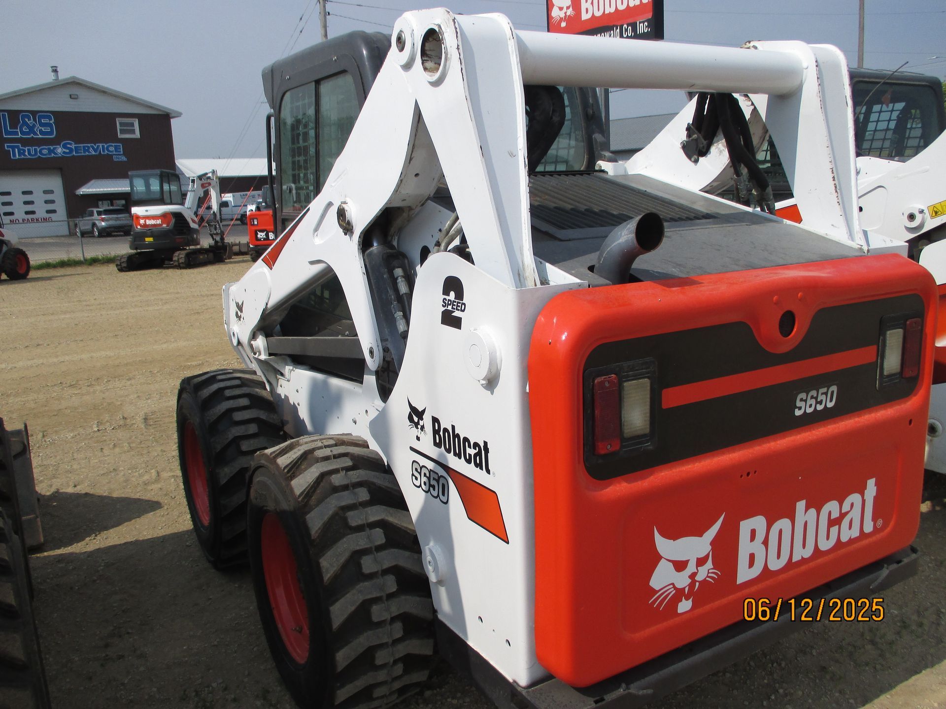 A bobcat skid steer is parked in front of a building