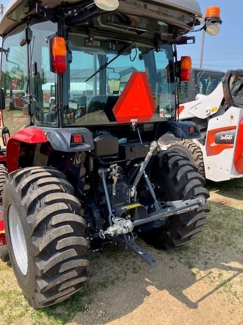 A tractor with a red sign on the back of it