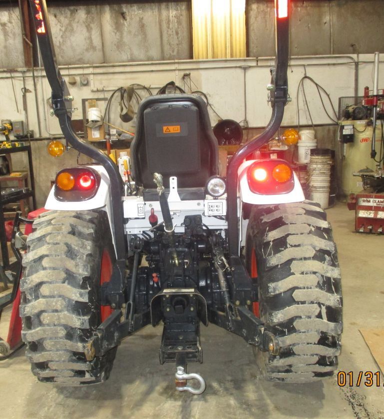 A tractor is parked in a garage with the date of january 31