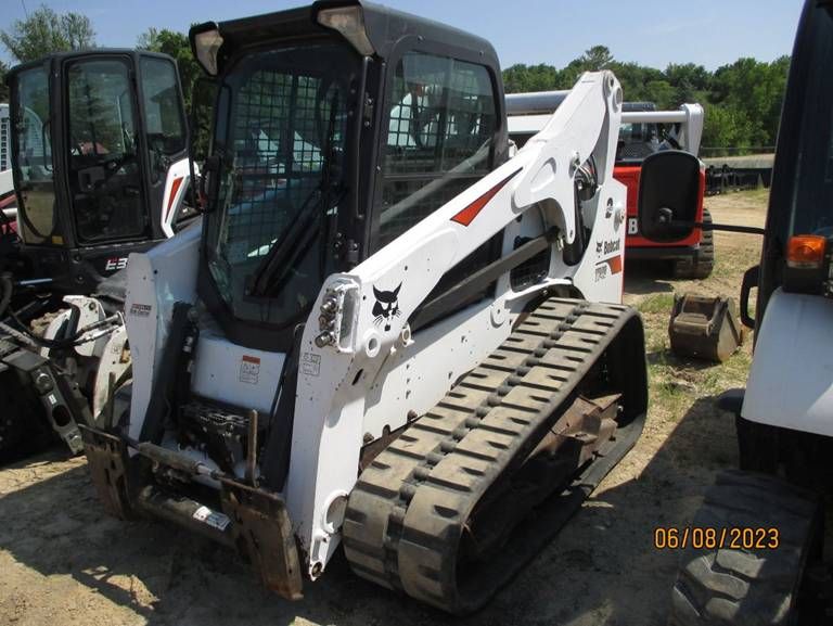 A bobcat track loader is parked in a lot