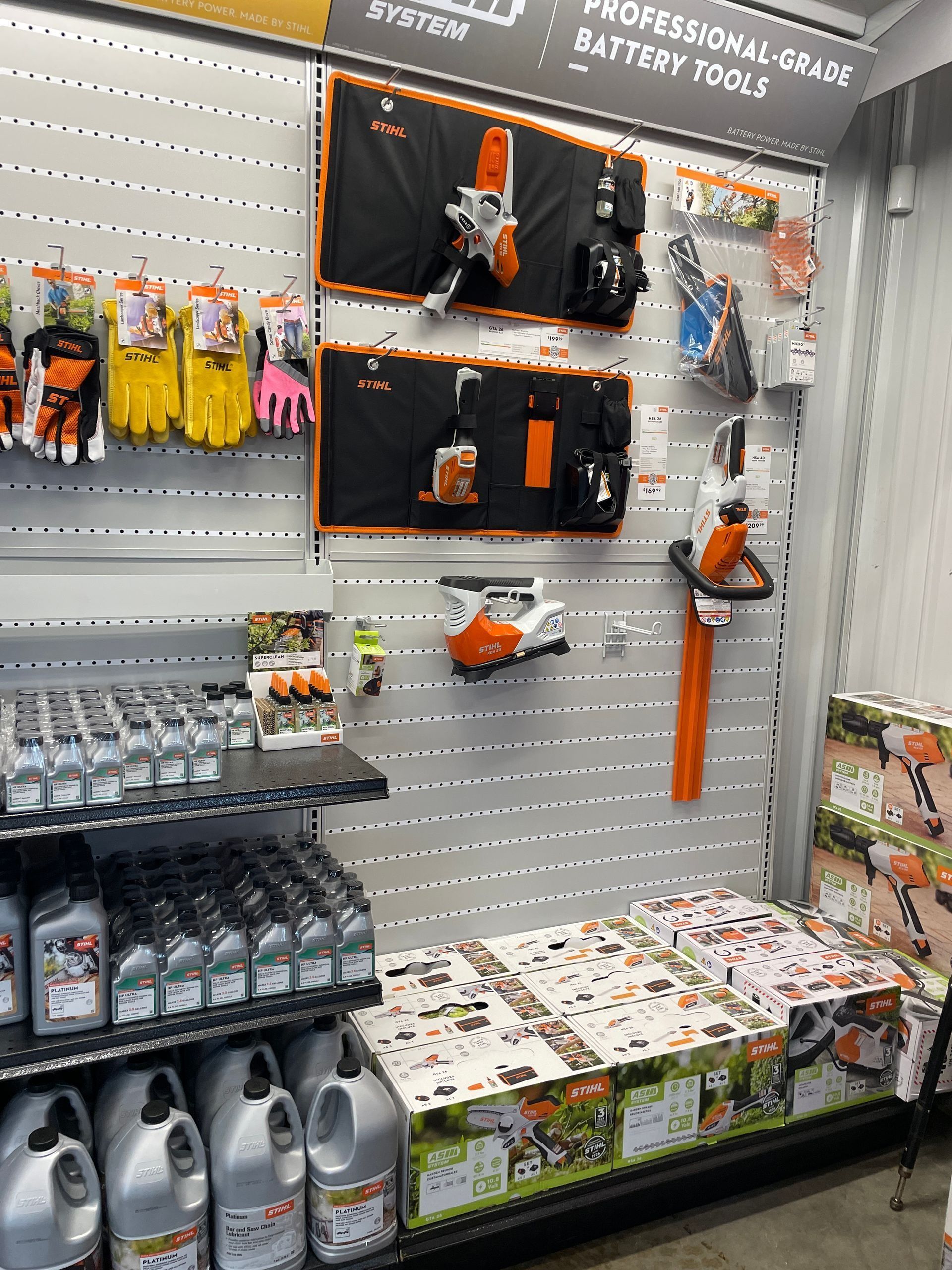 Display of Stihl outdoor power equipment and accessories in a store setting.