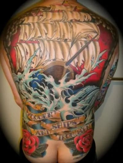Full back tattoo of a sailing ship on a rough sea with banners and roses; vibrant colors.