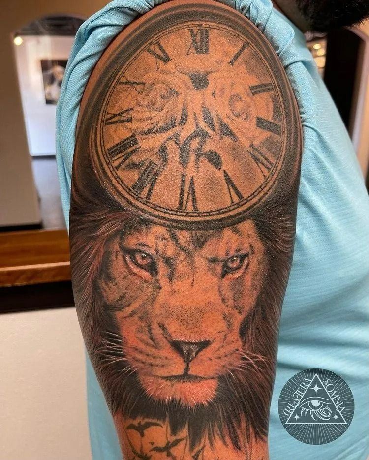 Lion head tattoo with clock face on arm.