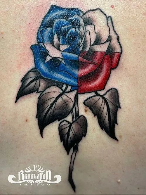 Tattoo of a rose split vertically with the Texas flag colors; blue and white on the left, red and white on the right.