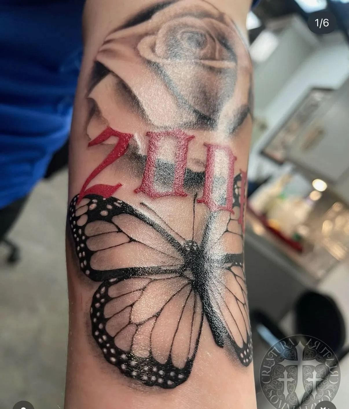 Tattoo of a white rose, red