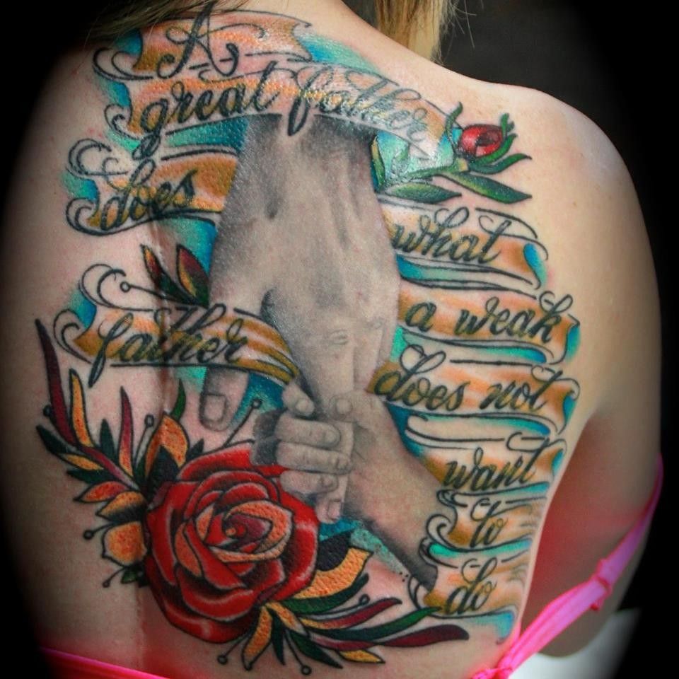 Tattoo on back: hands clasped, quote