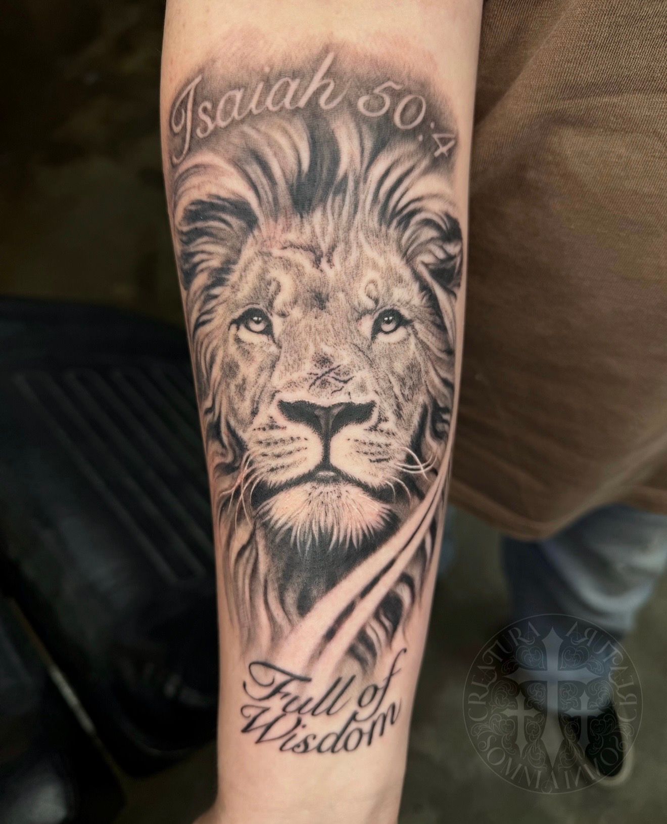 Black and white lion tattoo with scripture 