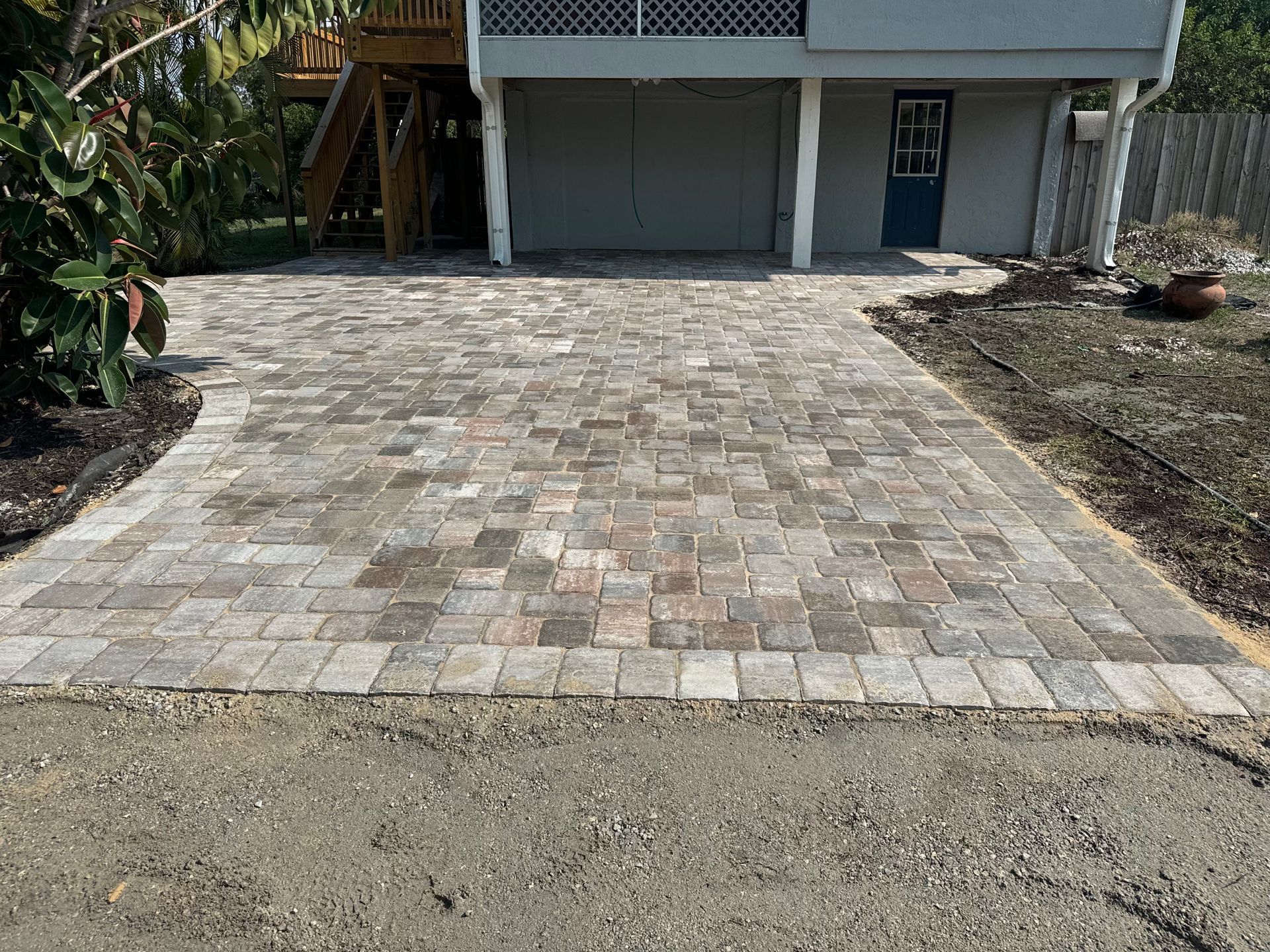 A driveway with bricks in front of a house.