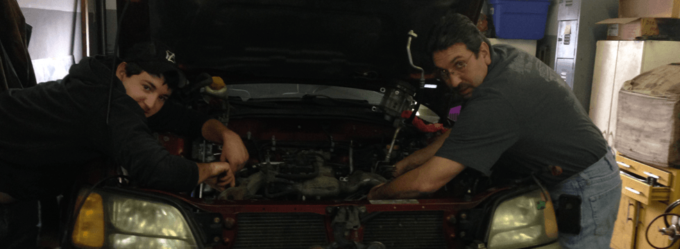Two guys repairing car