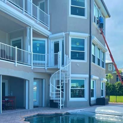 Apartment building with white balconies and a red ladder leaning against the side