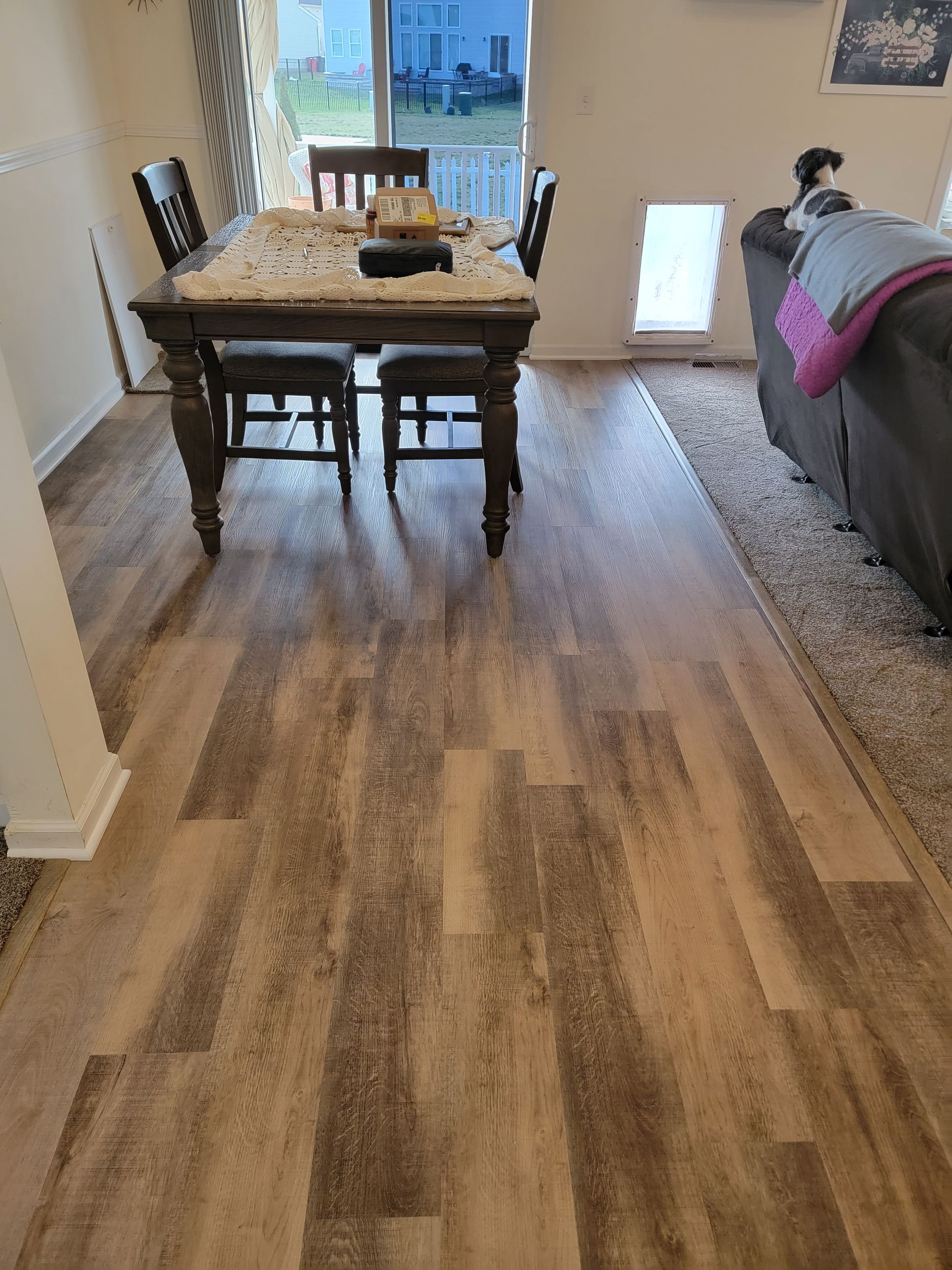 A dining room with a table and chairs in it.