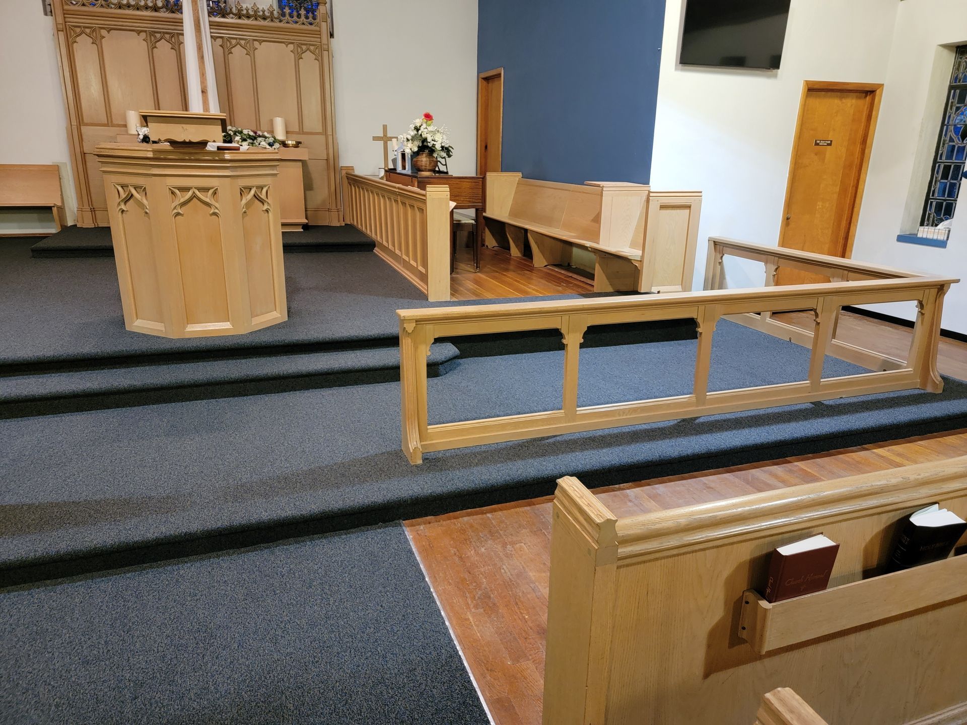 An empty church with a wooden podium and benches