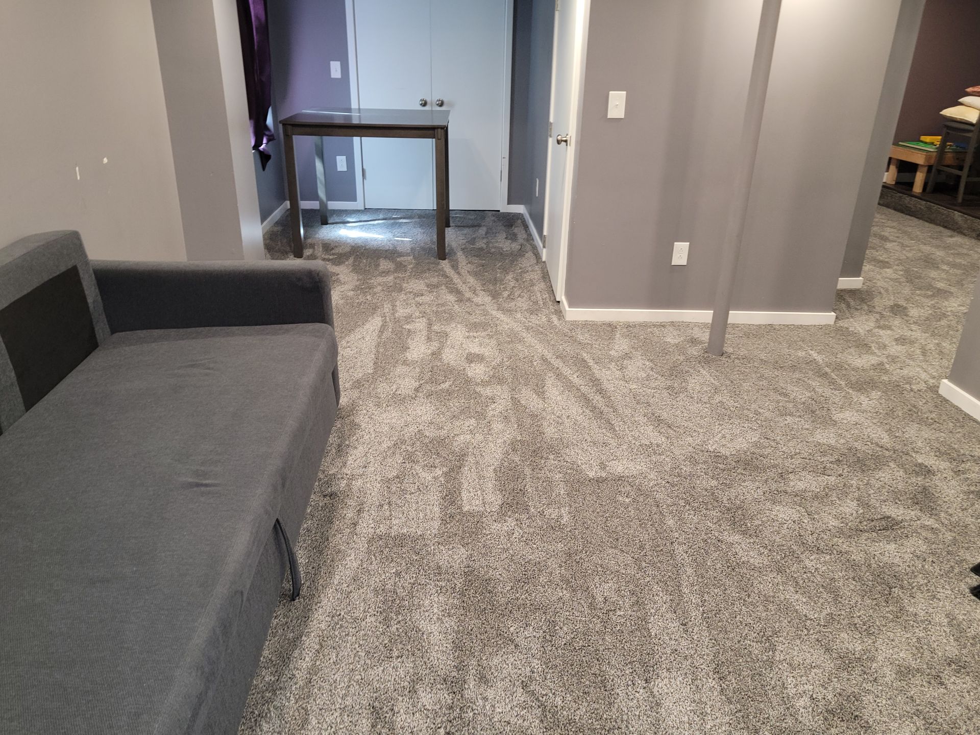 A living room with a couch and a table in it.