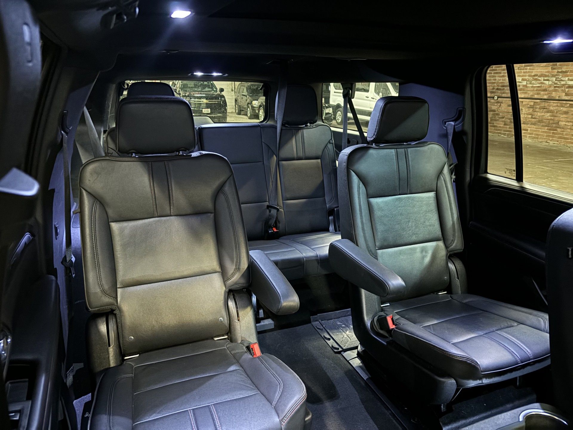 The interior of a black suv with leather seats.