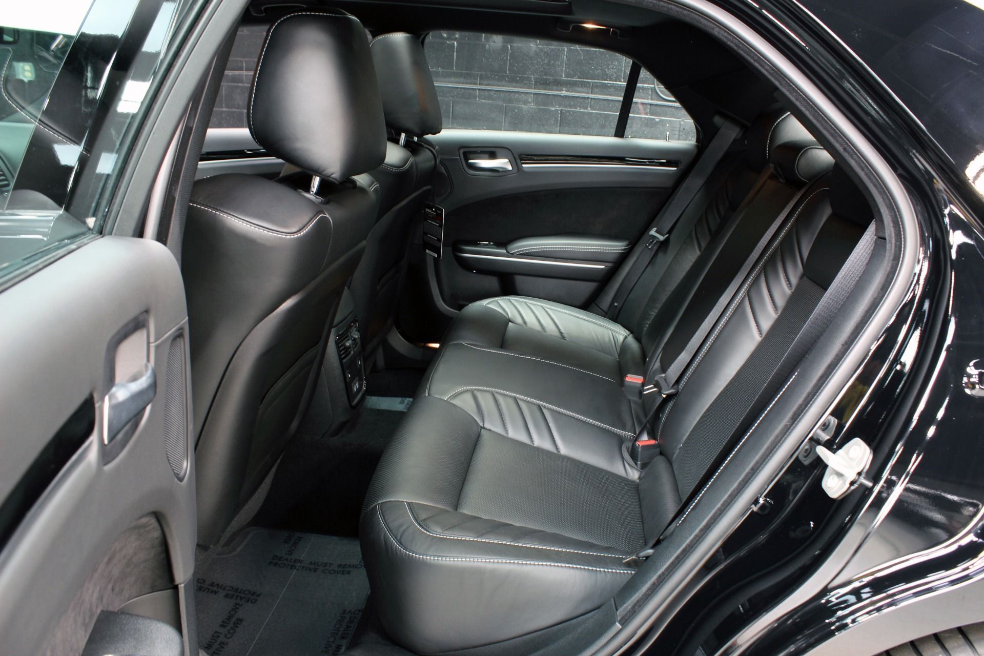The back seat of a black dodge charger is shown.