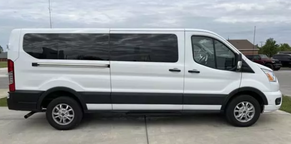 A white van is parked in a parking lot.