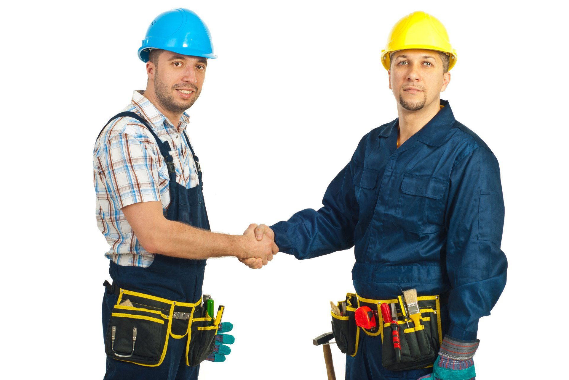Two construction workers in hard hats and tool belts shaking hands.
