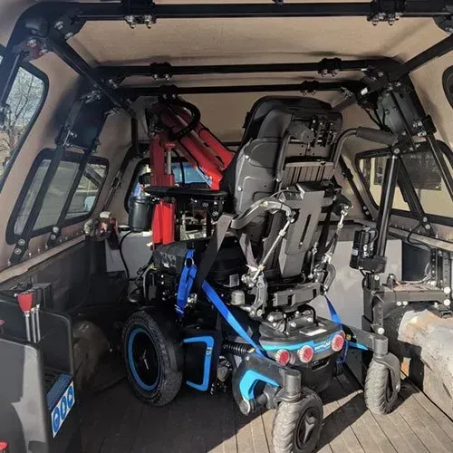 Wheelchair secured inside truck bed with custom rack system.