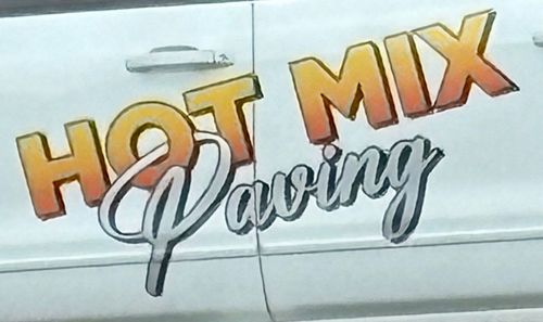 A white van with the words hot mix paving on the side