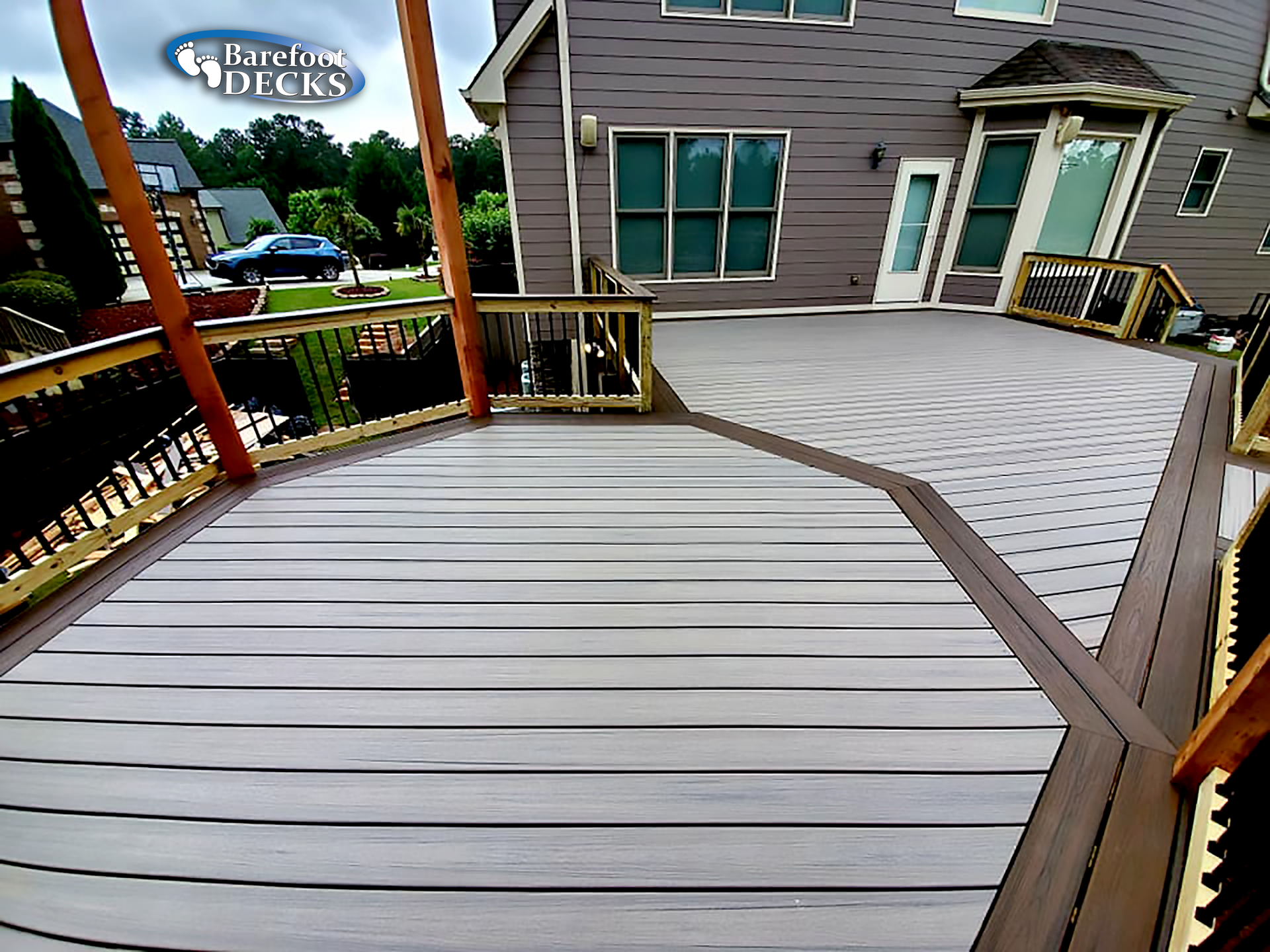 Composite deck with multiple levels, brown trim, gray decking.