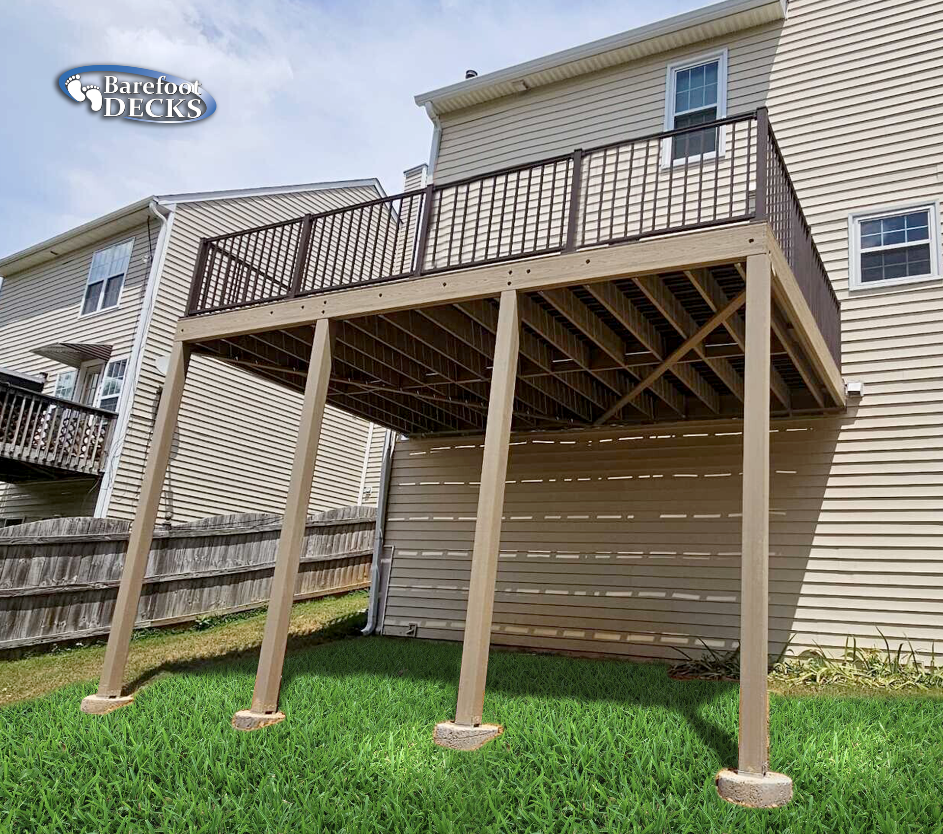 Deck with brown railing and supports, attached to a two-story beige house, over a slatted enclosure.